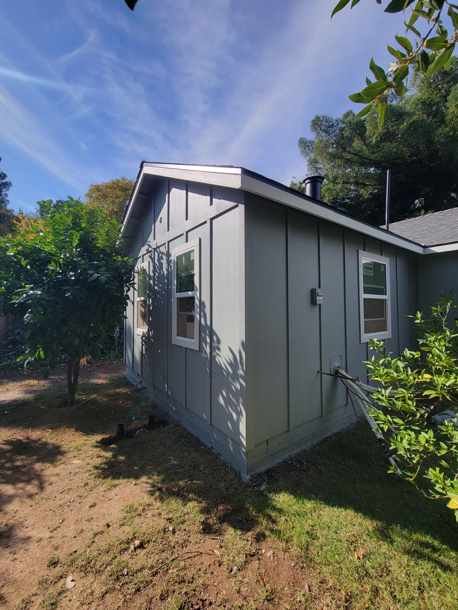 48th St. ADU exterior, side elevation with board-and-batten siding and metal roof