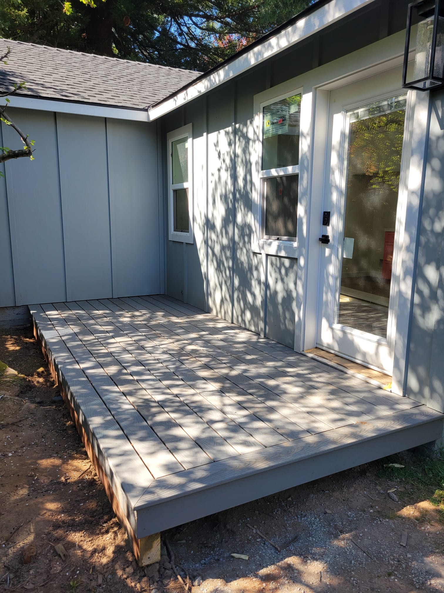 48th St. ADU exterior with covered back deck and glass entry door