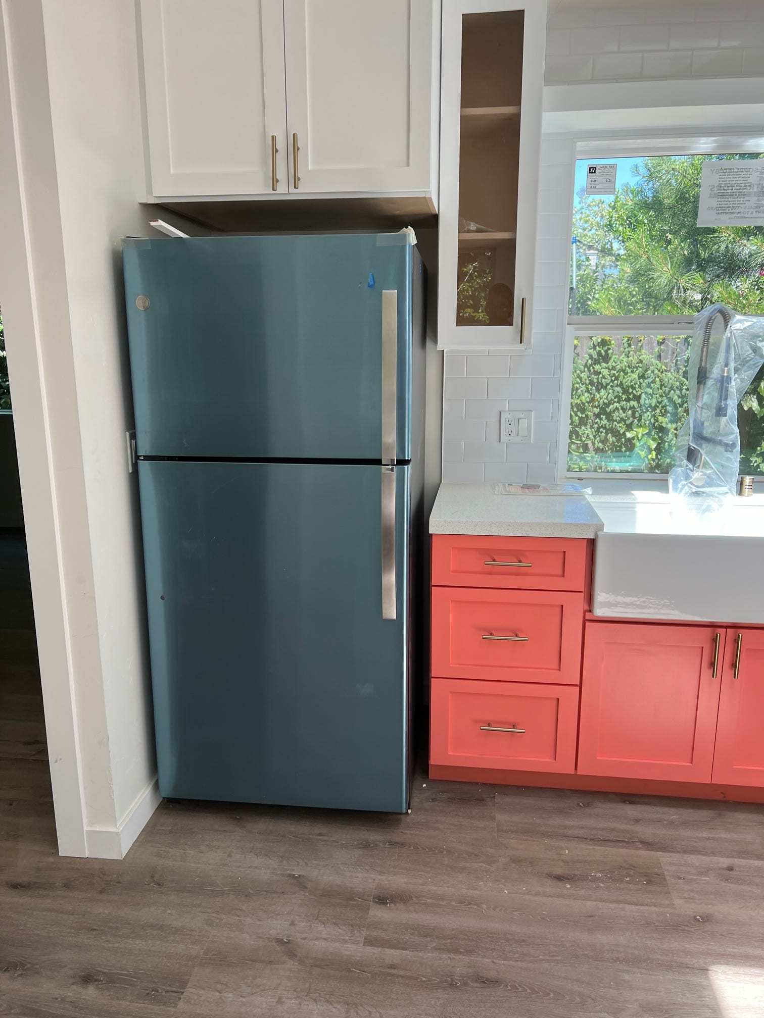 48th St. ADU kitchen refrigerator and coral cabinetry