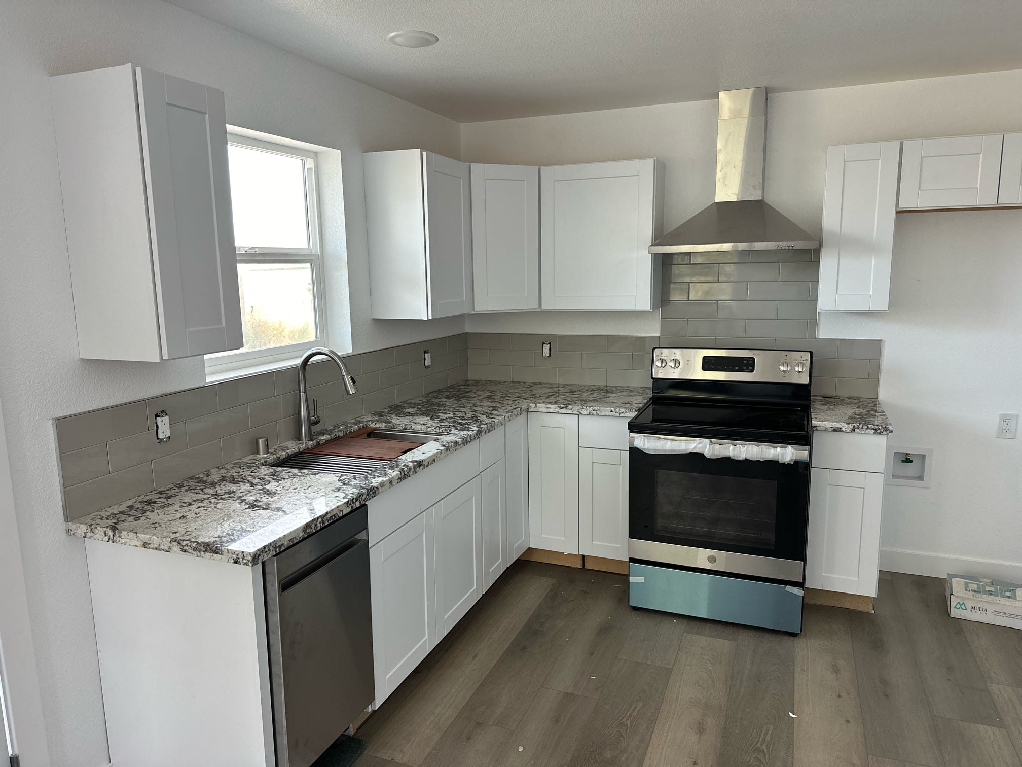 ADU kitchen with white cabinets and stainless appliances