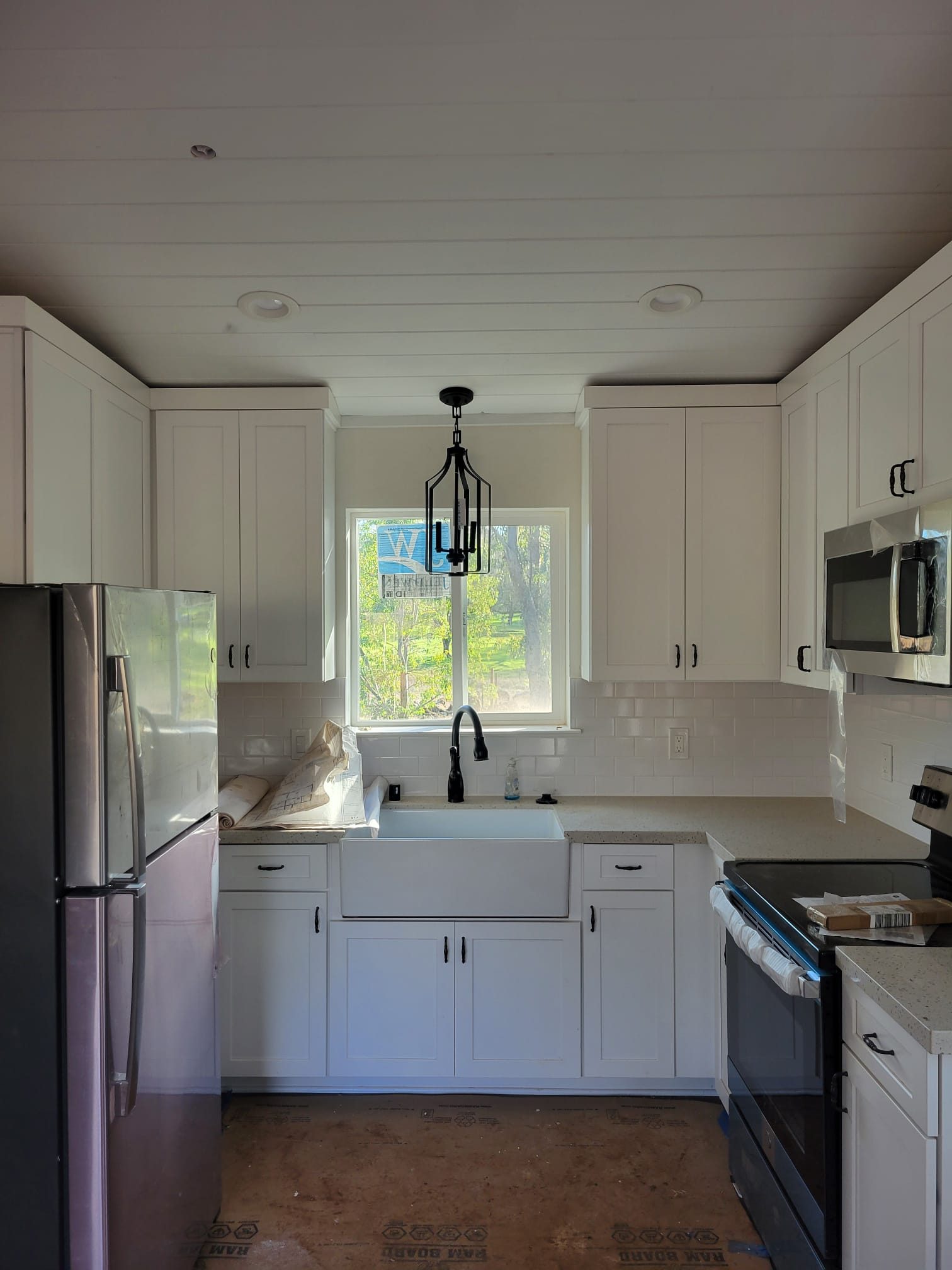 ADU kitchen with farmhouse sink under window