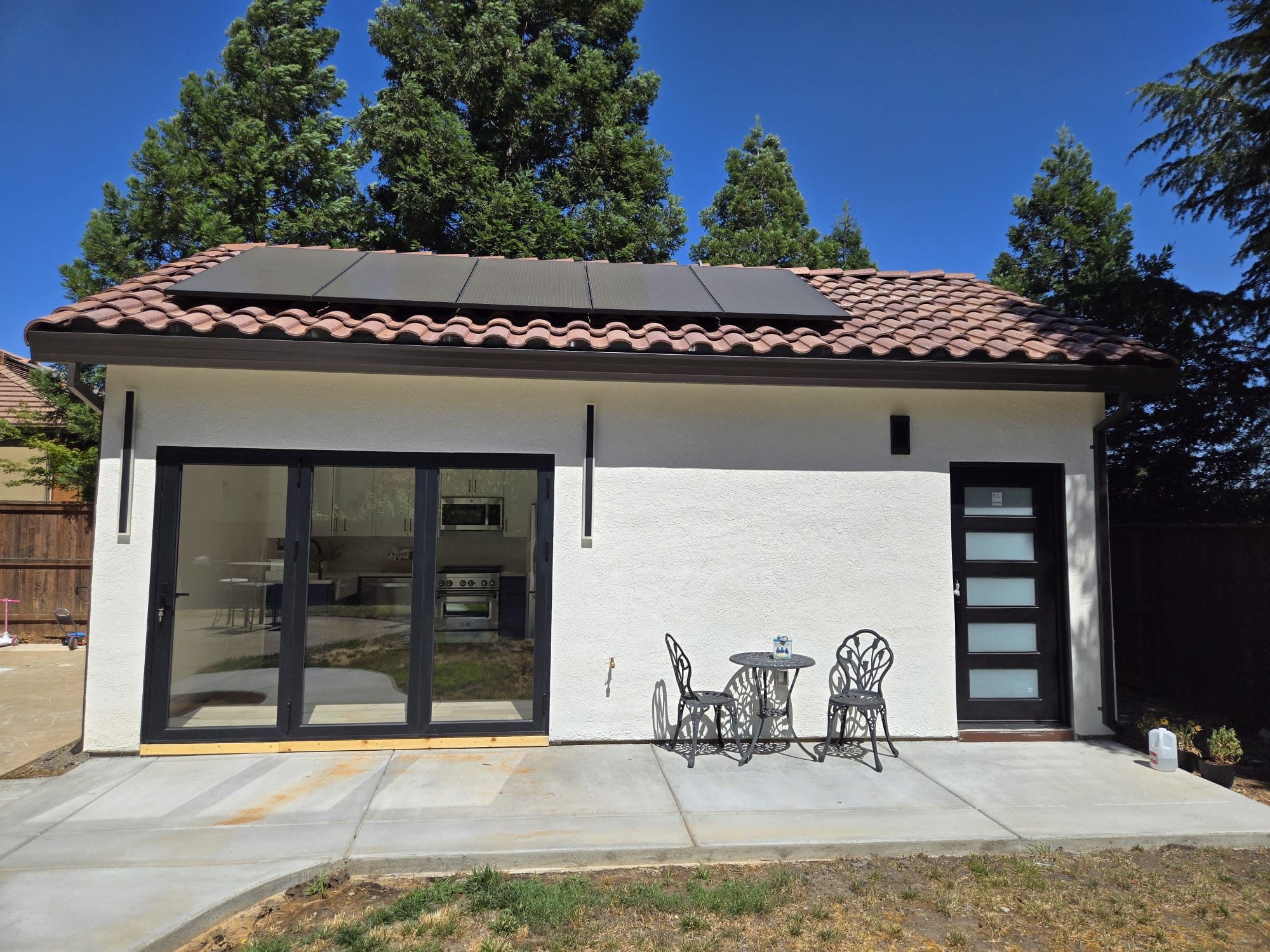 ADU exterior with Spanish tile roof and covered patio