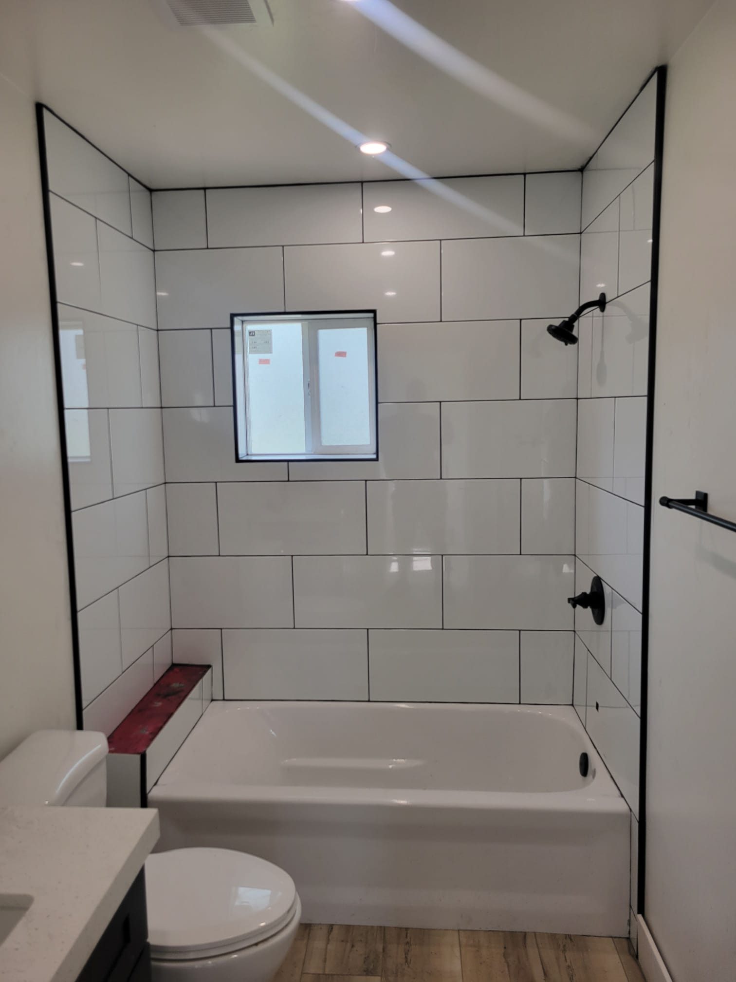ADU bathroom with tiled tub/shower