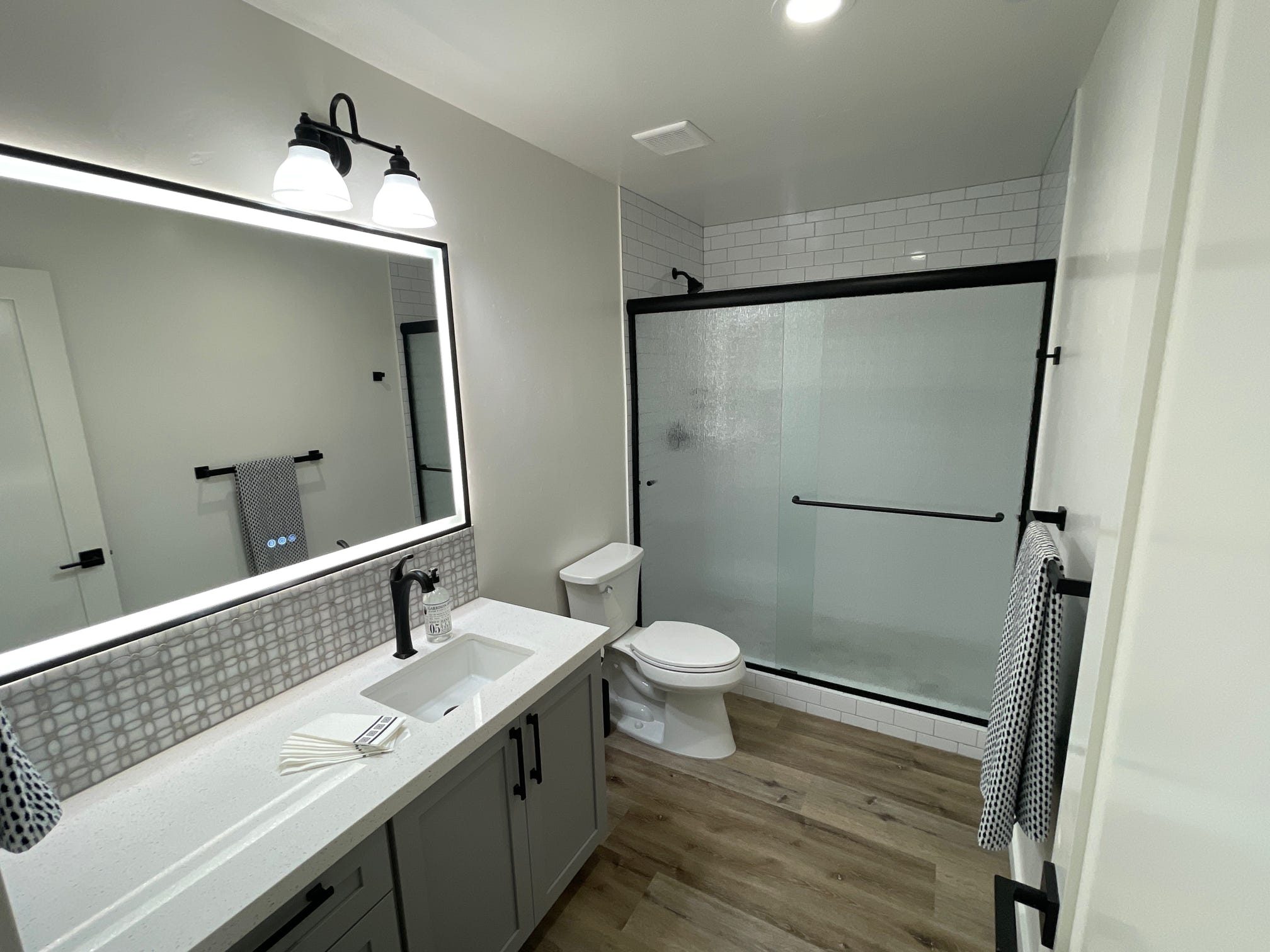 ADU bathroom vanity with backlit mirror