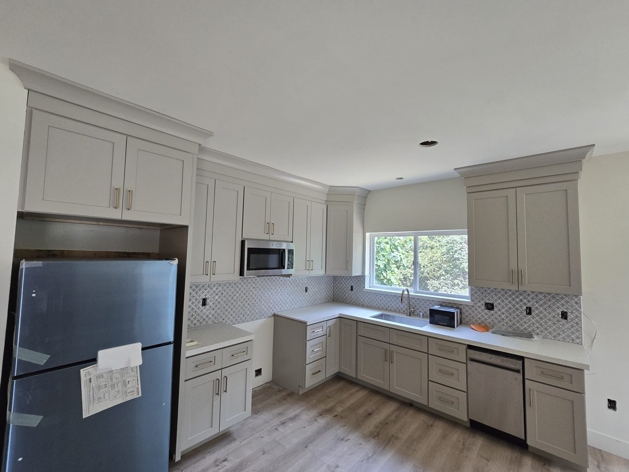 ADU kitchen with white cabinets