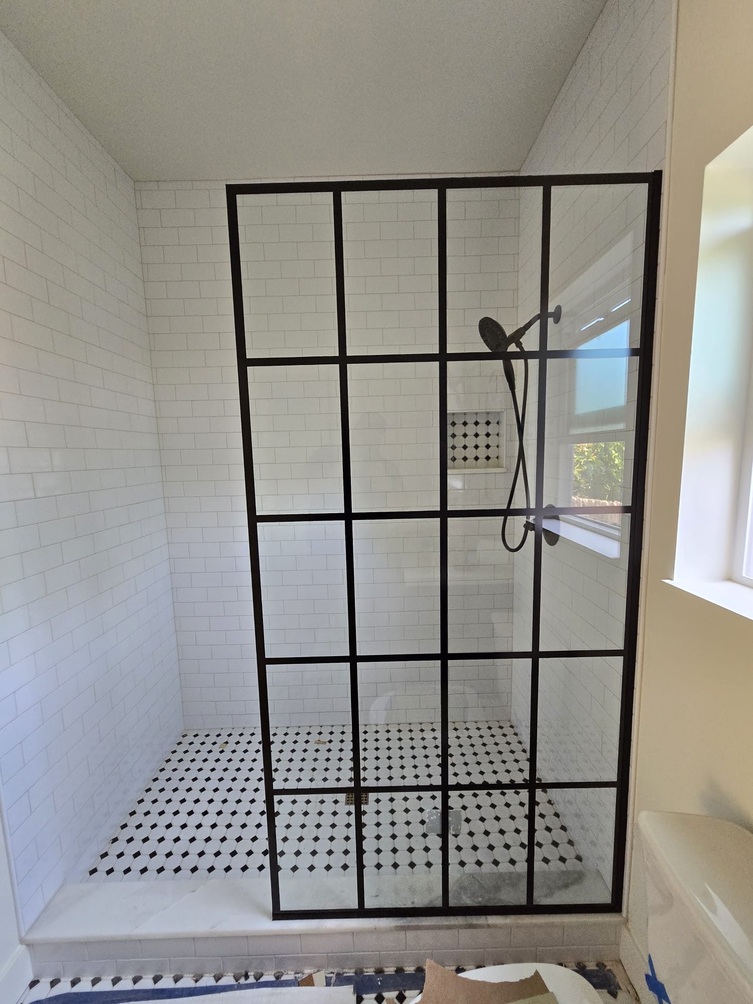 ADU bathroom with black-framed glass shower