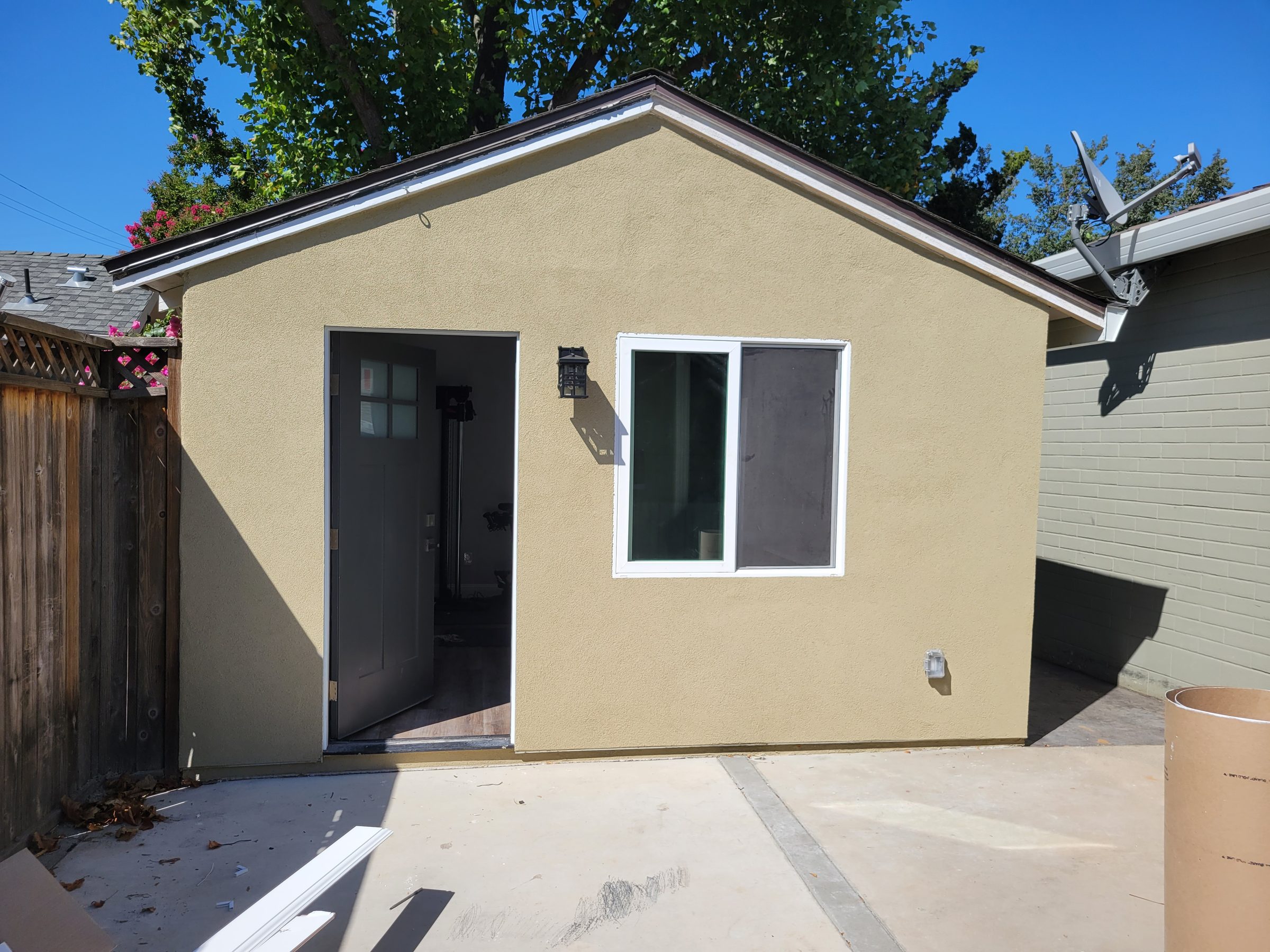 Garage conversion ADU exterior, finished stucco and deck
