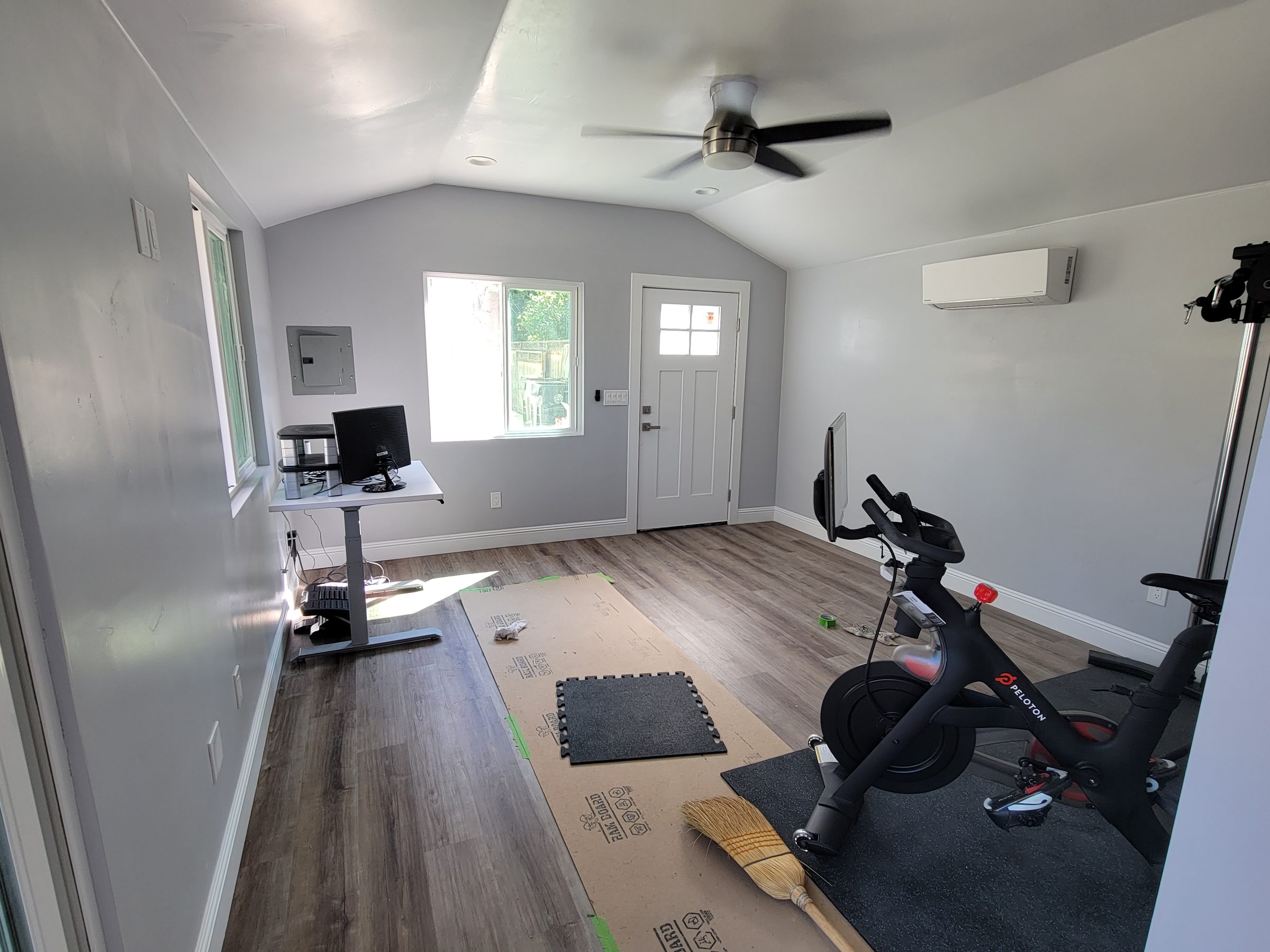 ADU home gym with mini-split and wood flooring