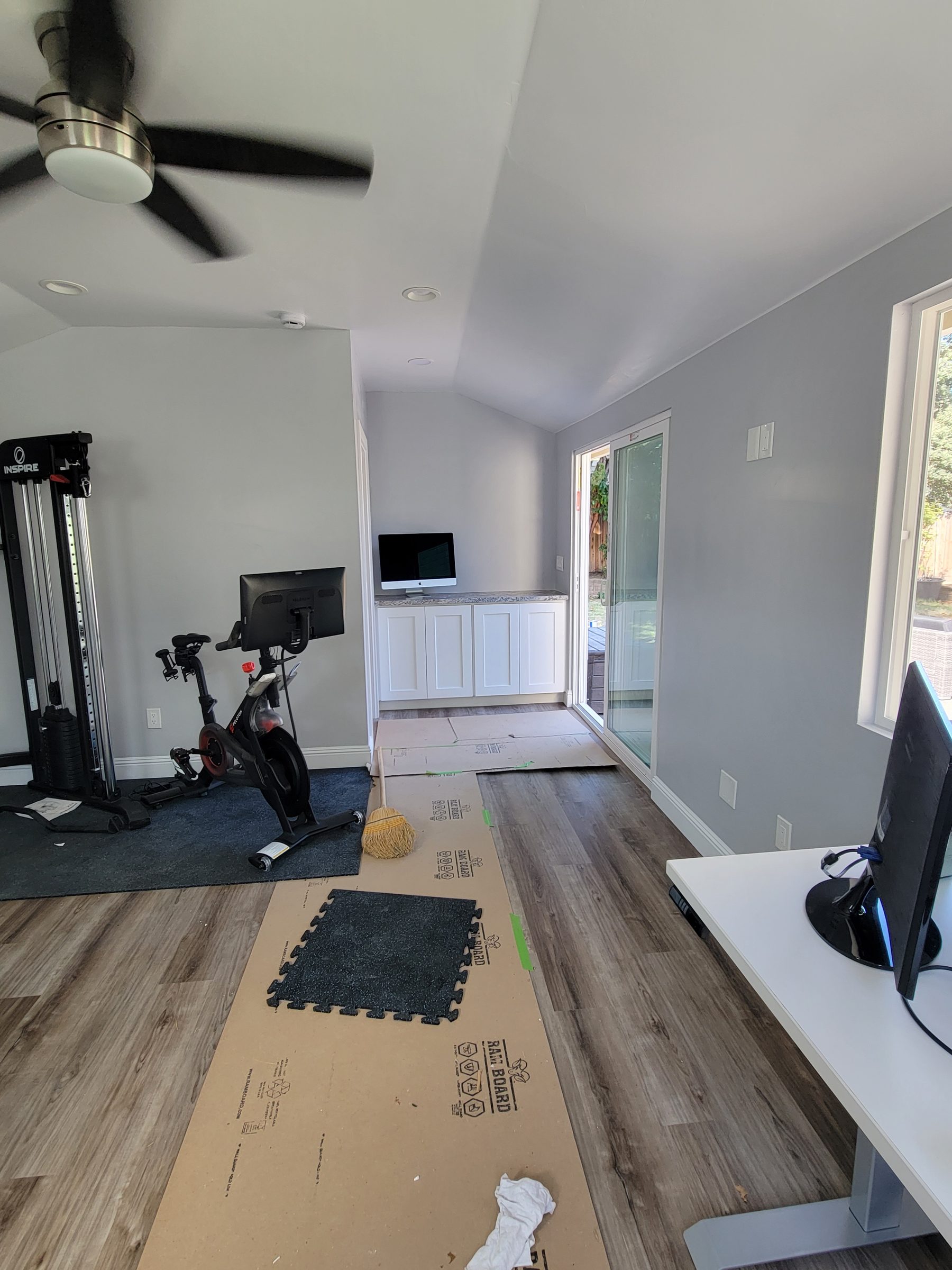 ADU home gym with kitchenette counter visible