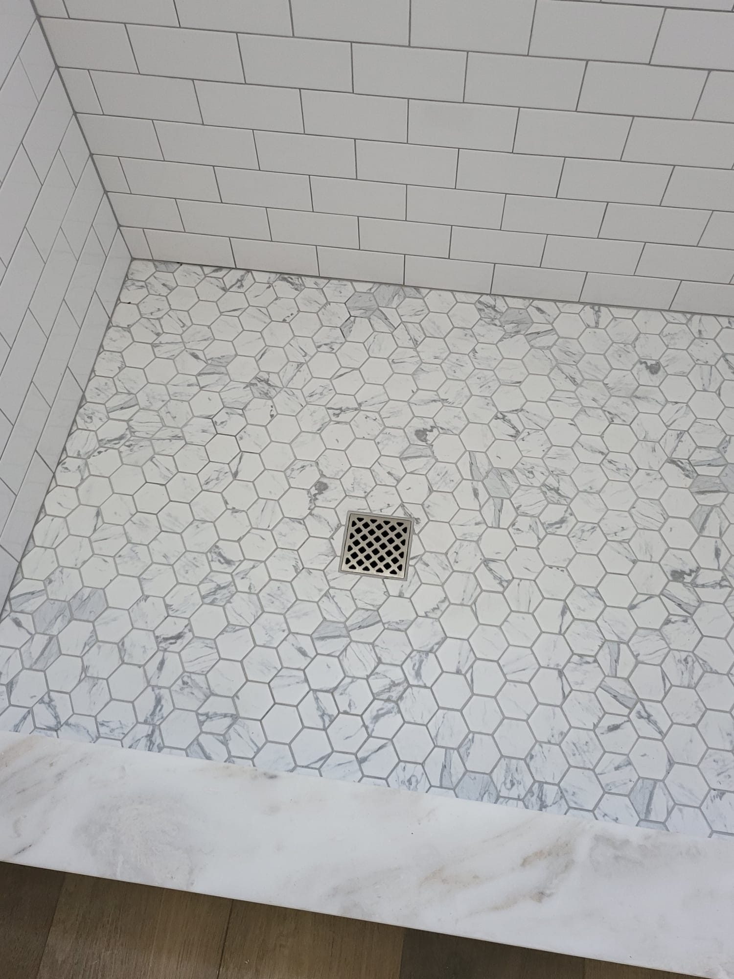 ADU bathroom shower floor with marble hexagon tile