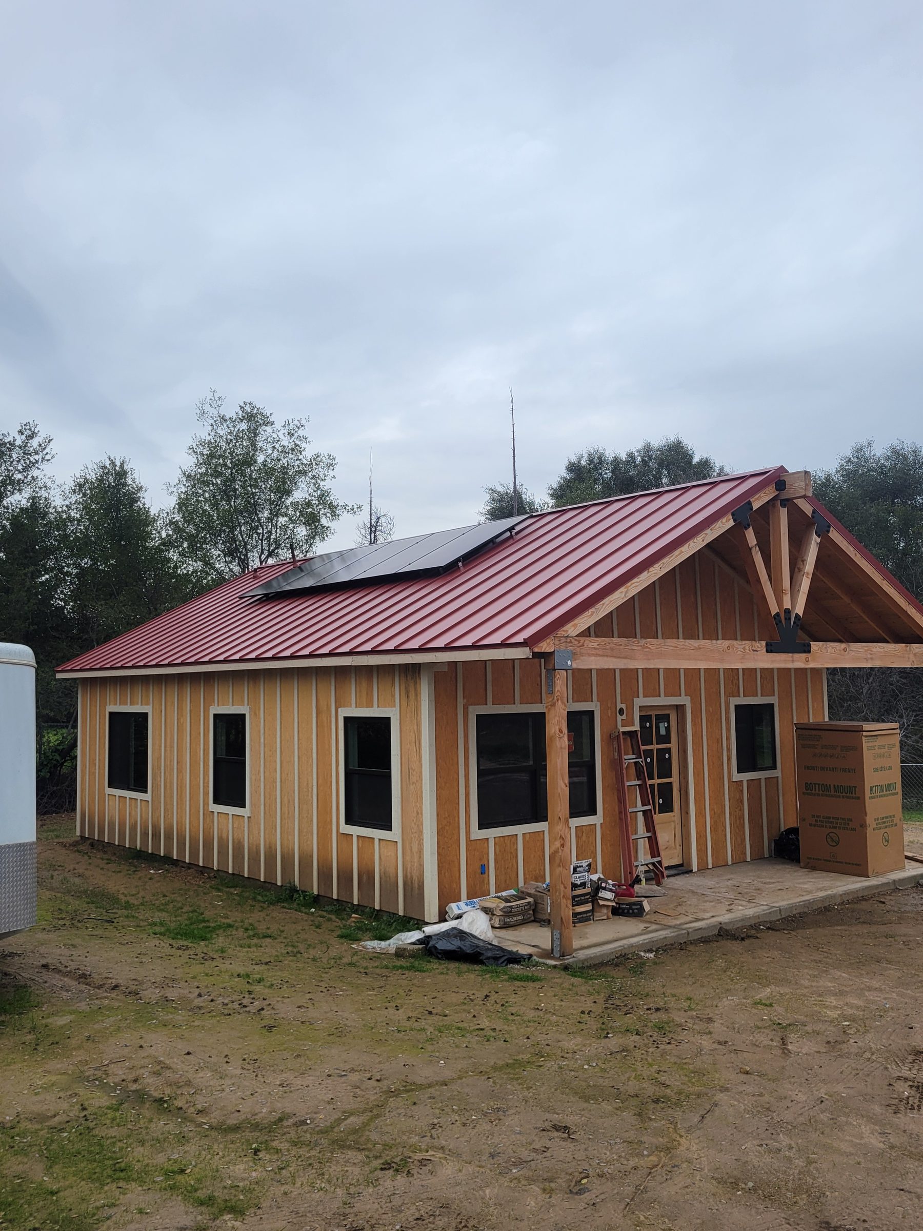 Barn-style ADU exterior with metal roof, completed