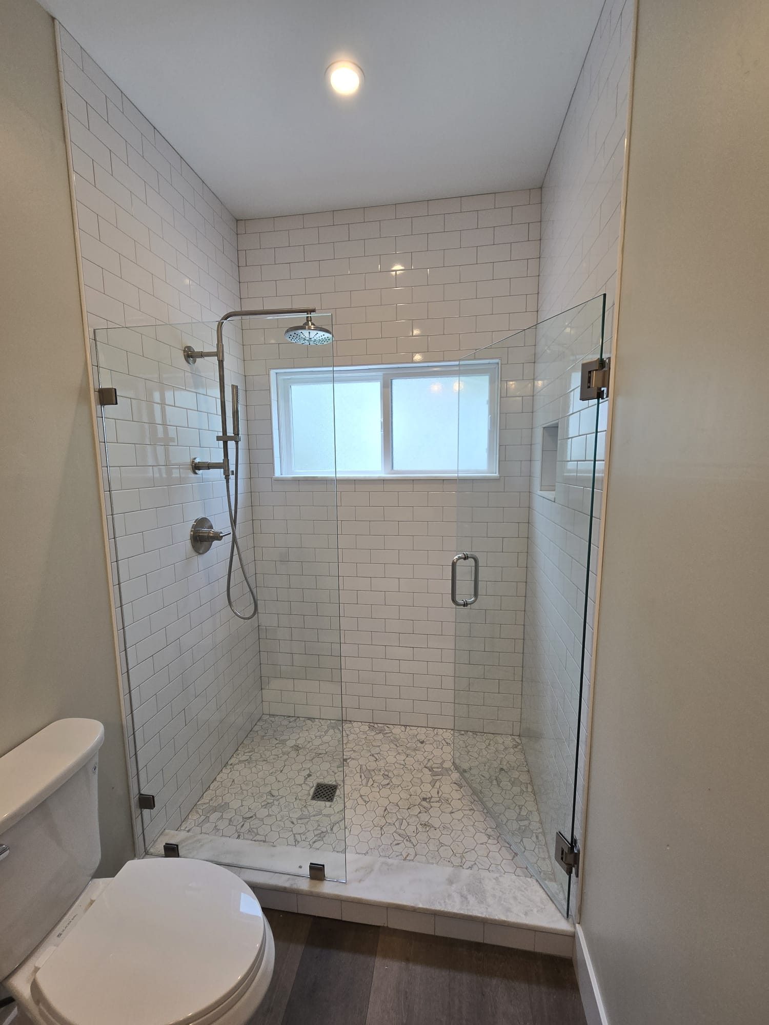 ADU bathroom with glass shower and window