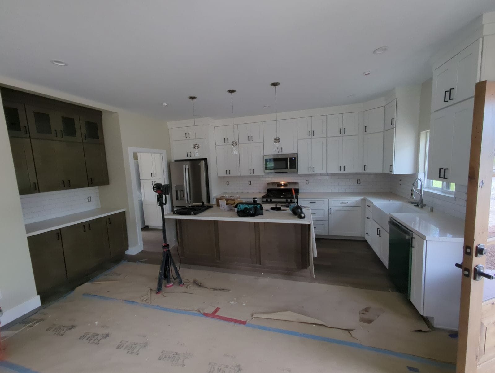ADU kitchen with white cabinets and dark island