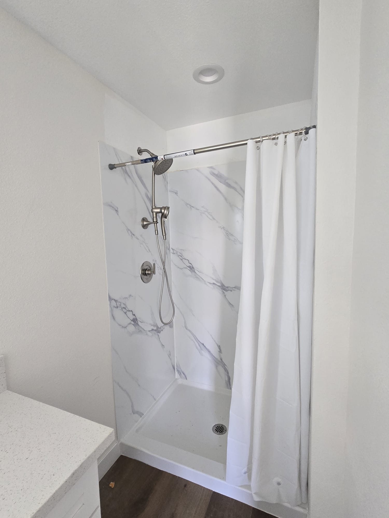 ADU bathroom with marble-look shower surround