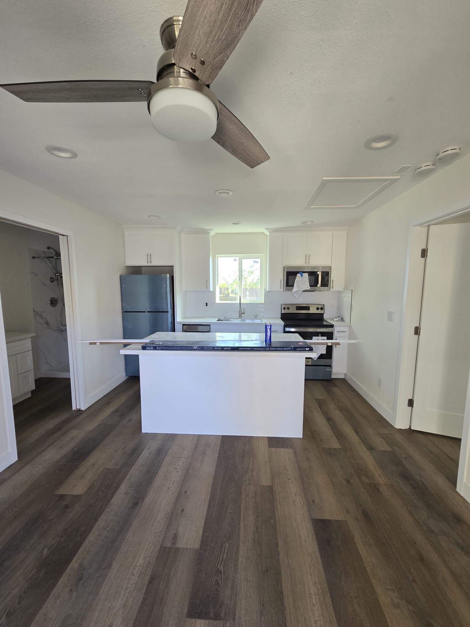 ADU kitchen with white island and ceiling fan