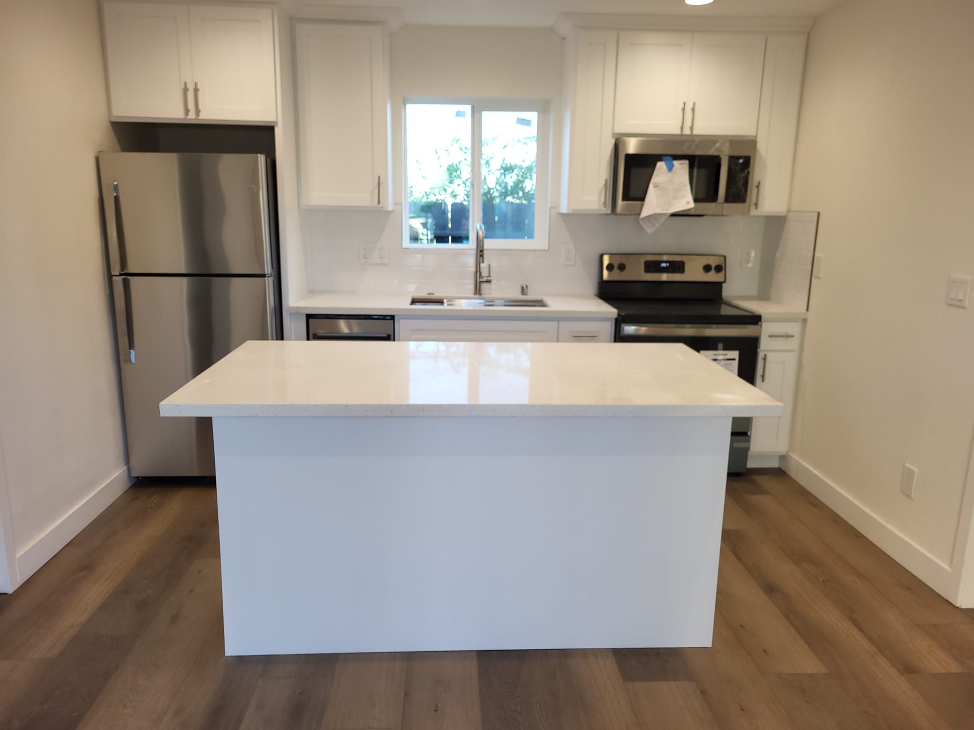 ADU kitchen with white island, completed
