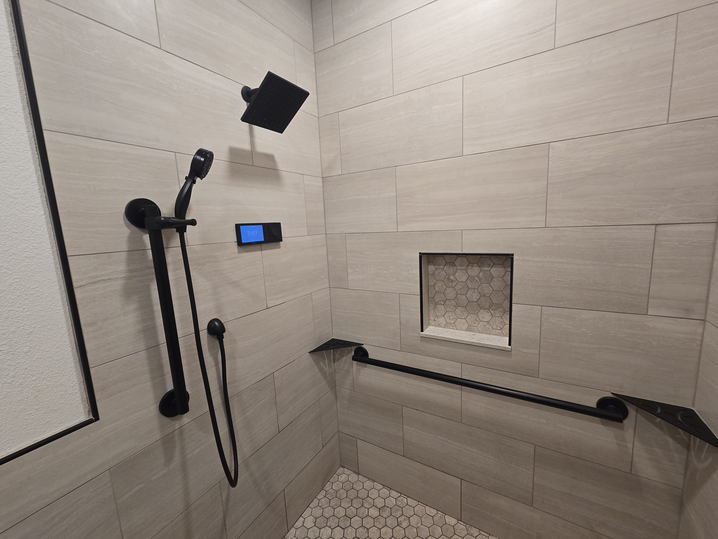 Curbless shower with tiled niche and grab bar