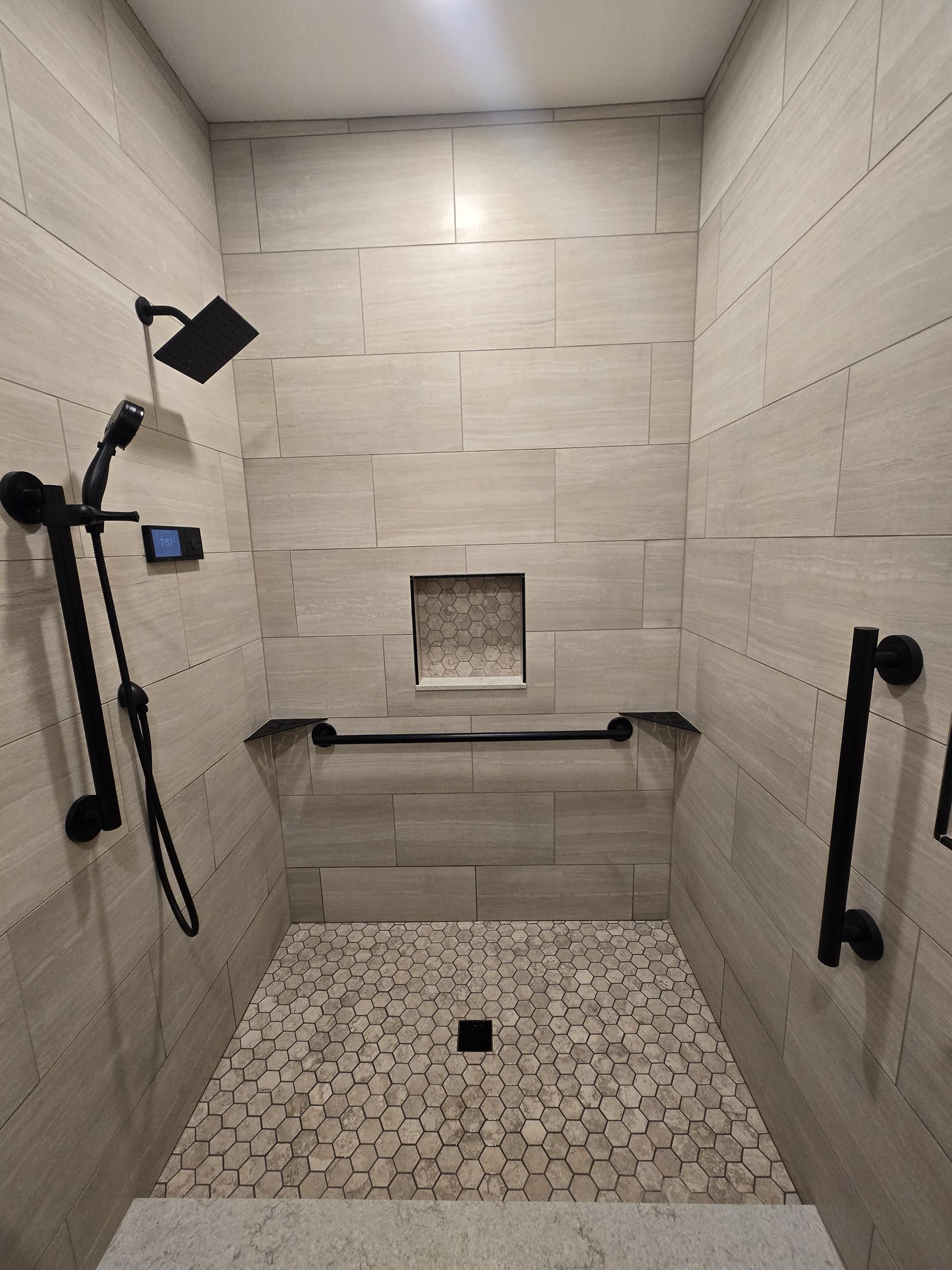 Curbless shower with hexagon tile floor, straight-on view