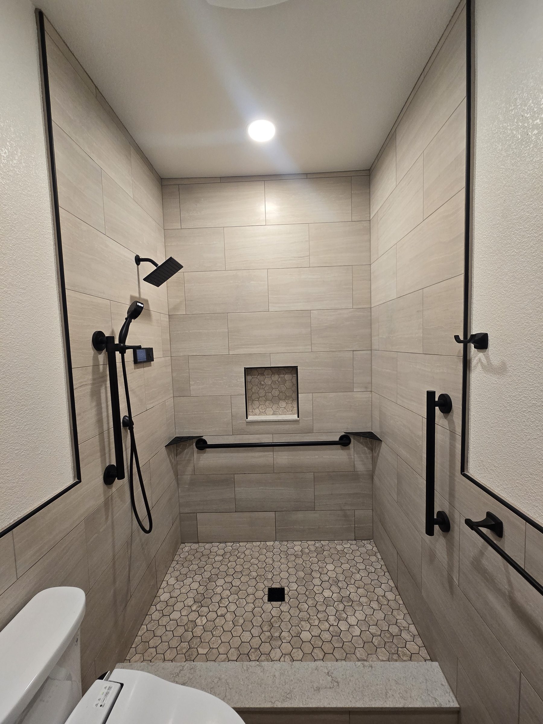 Curbless shower with toilet visible in foreground