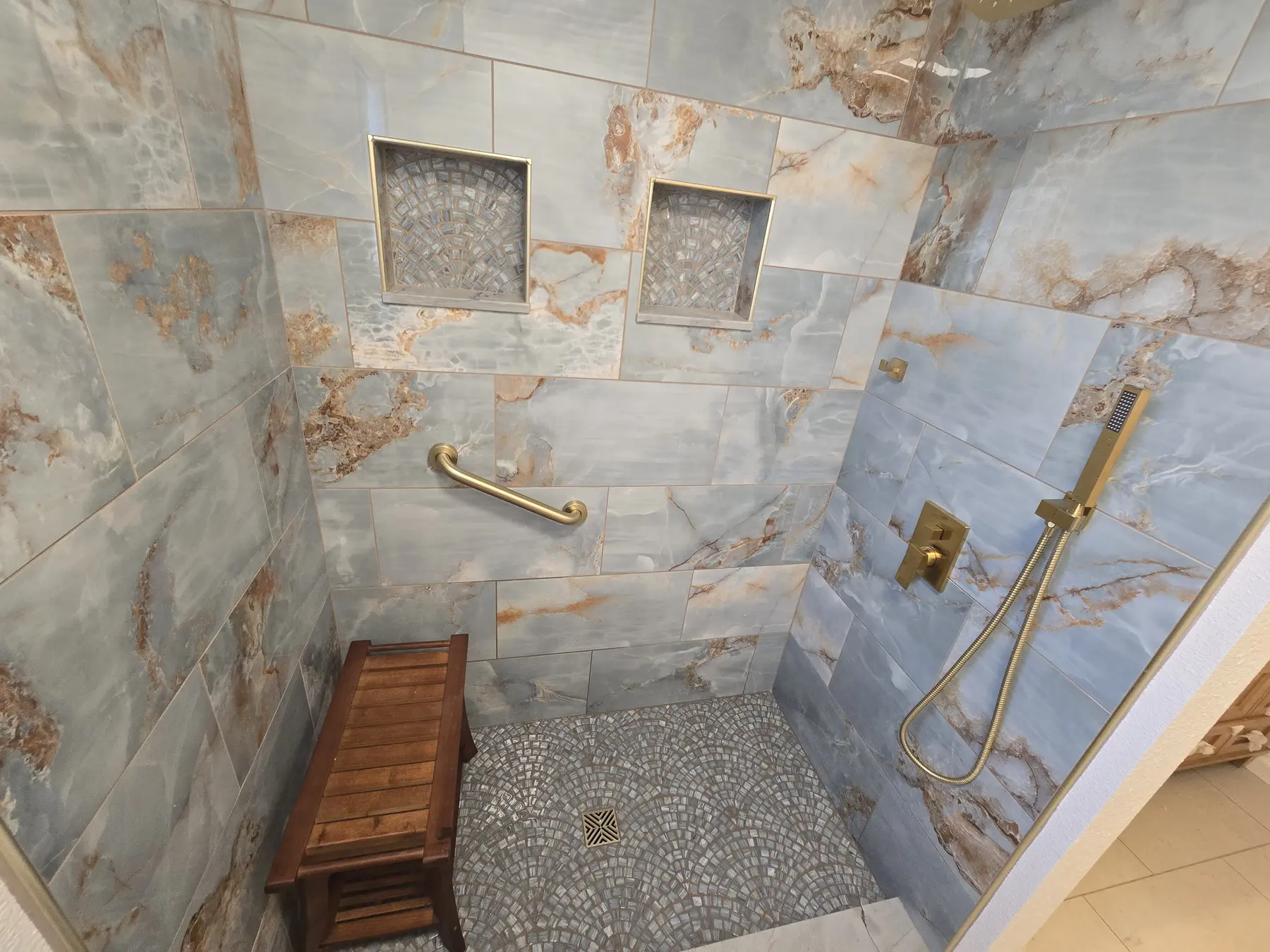 Finished accessible bathroom with blue stone shower floor