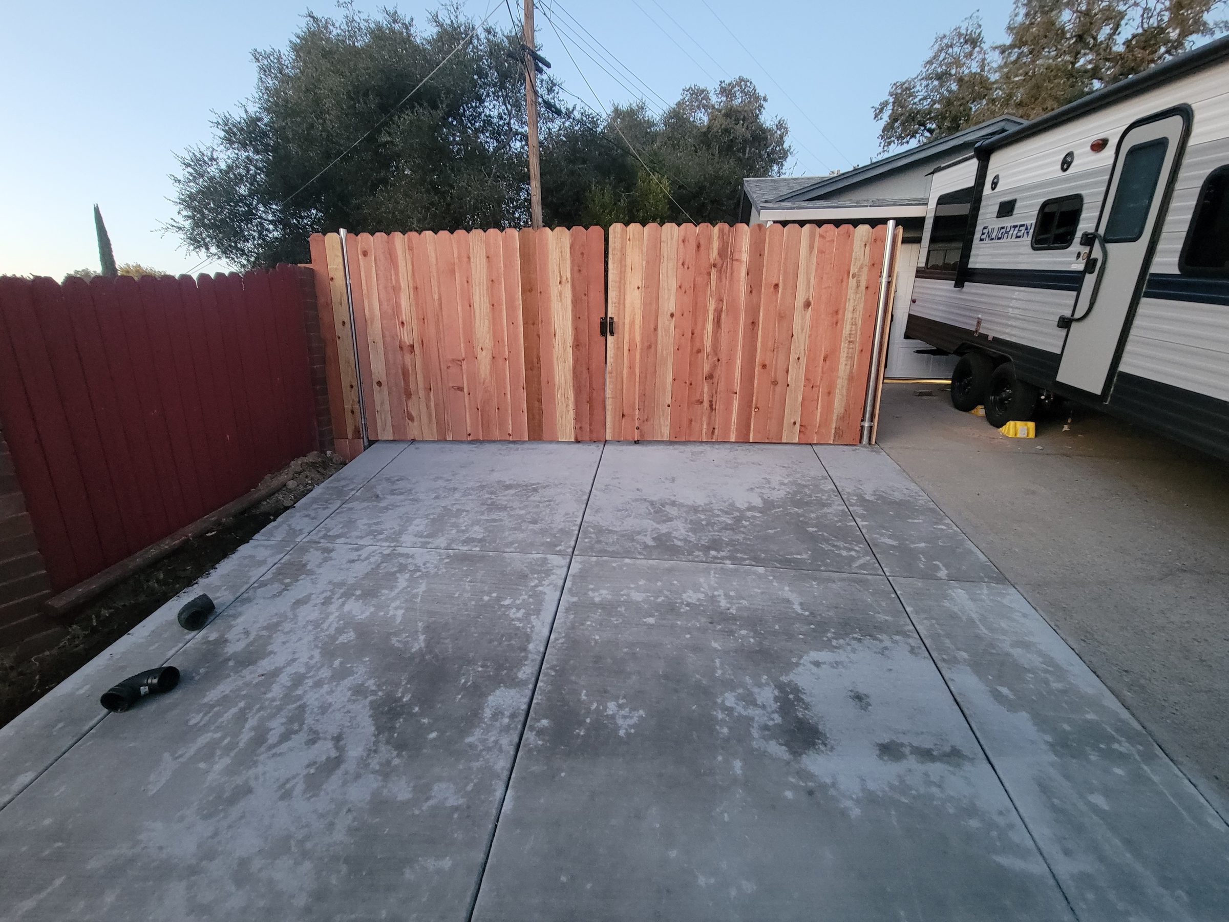 Finished driveway and wood gate seen from the side