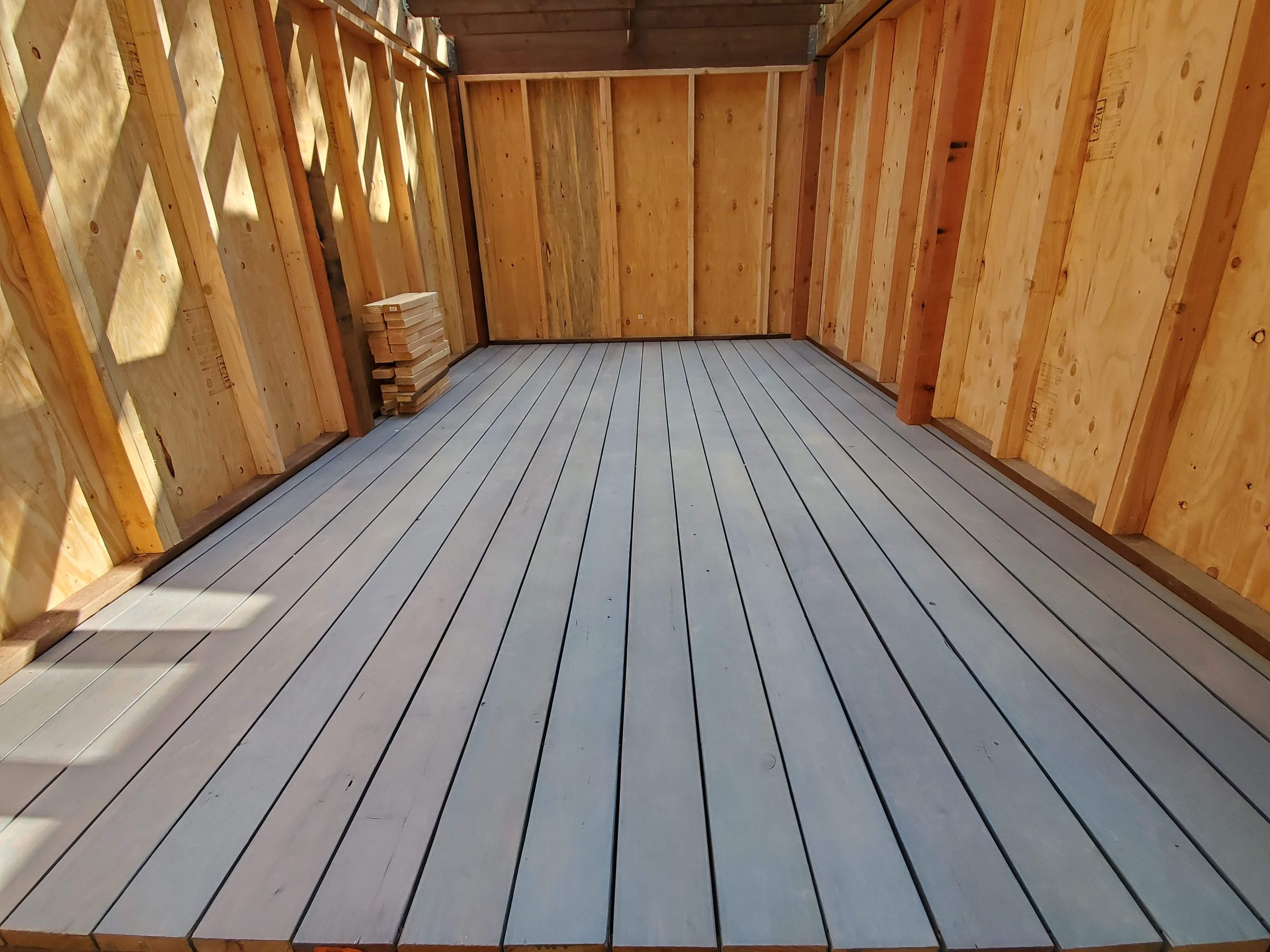 Gray deck boards inside the framed structure