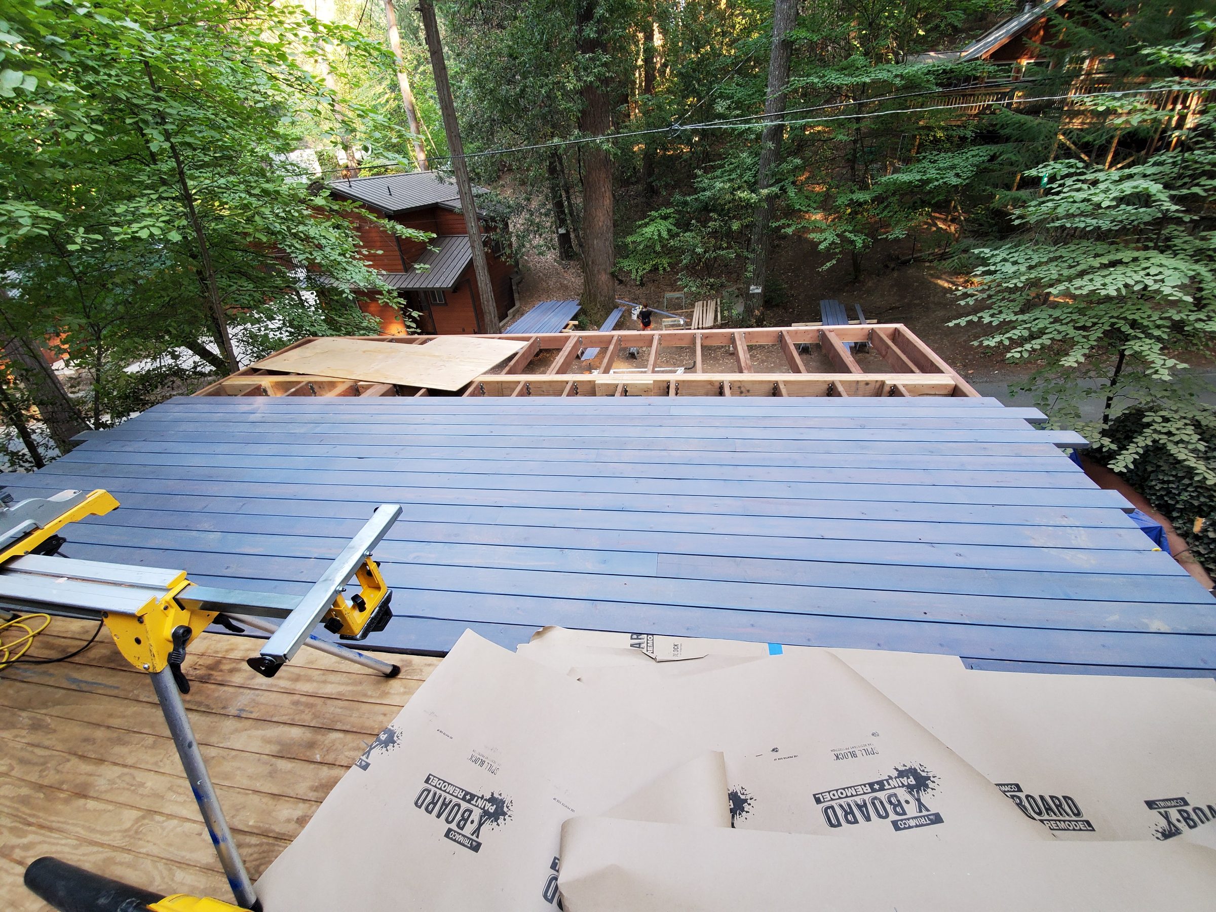 Deck boards going down while wall framing continues