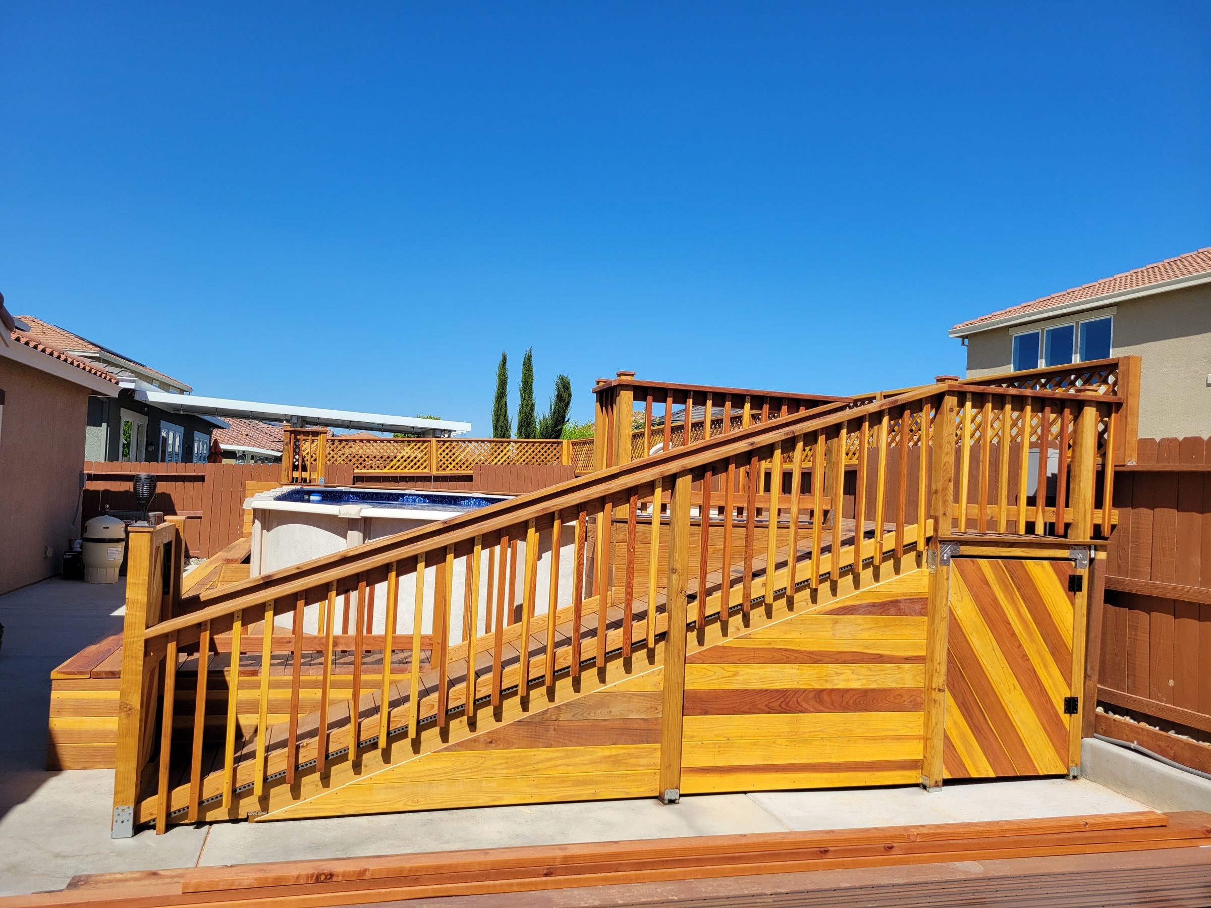 Elevated pool deck with covered entertainment structure