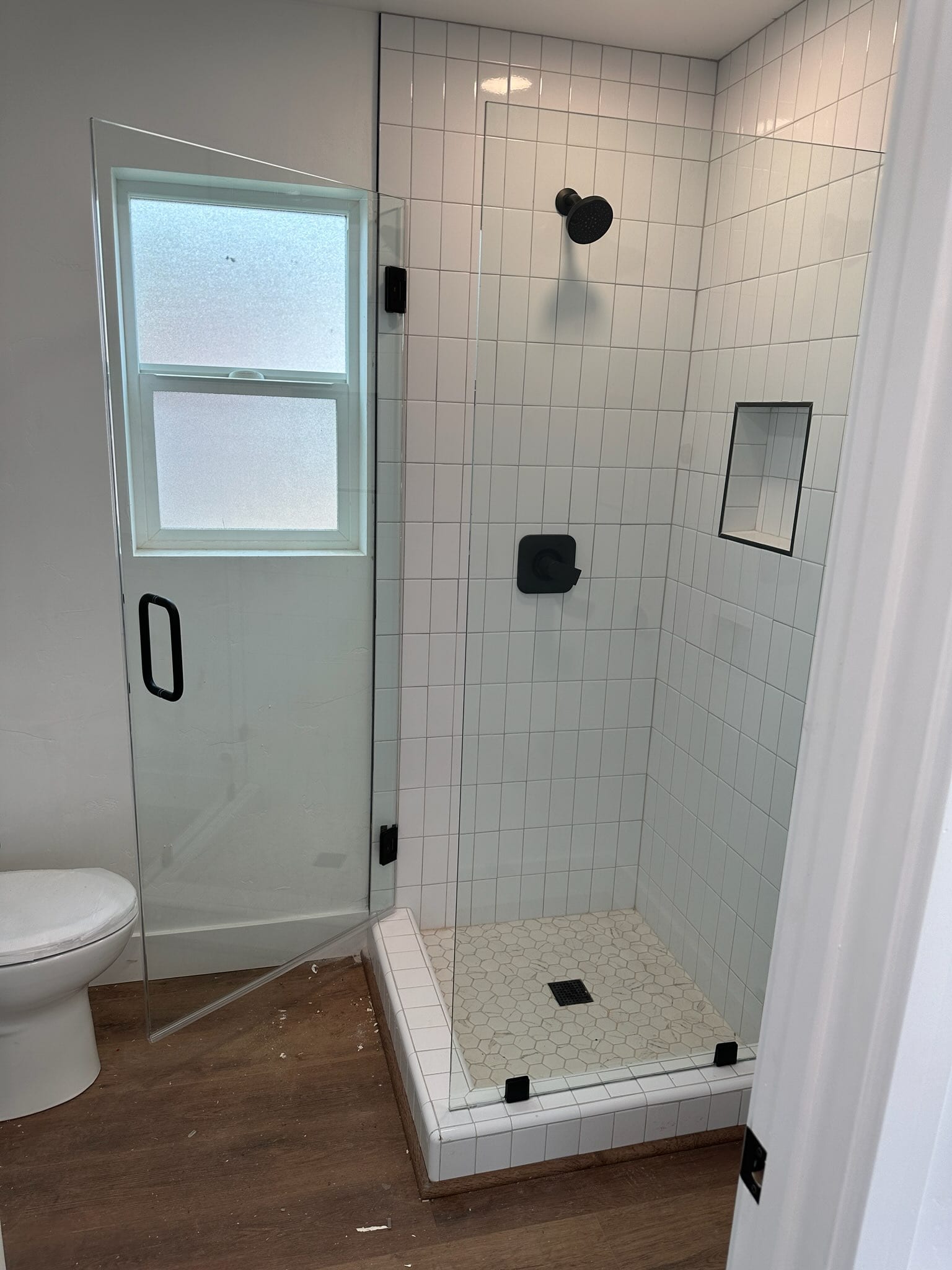East Sac ADU bathroom with white subway tile shower and black fixtures