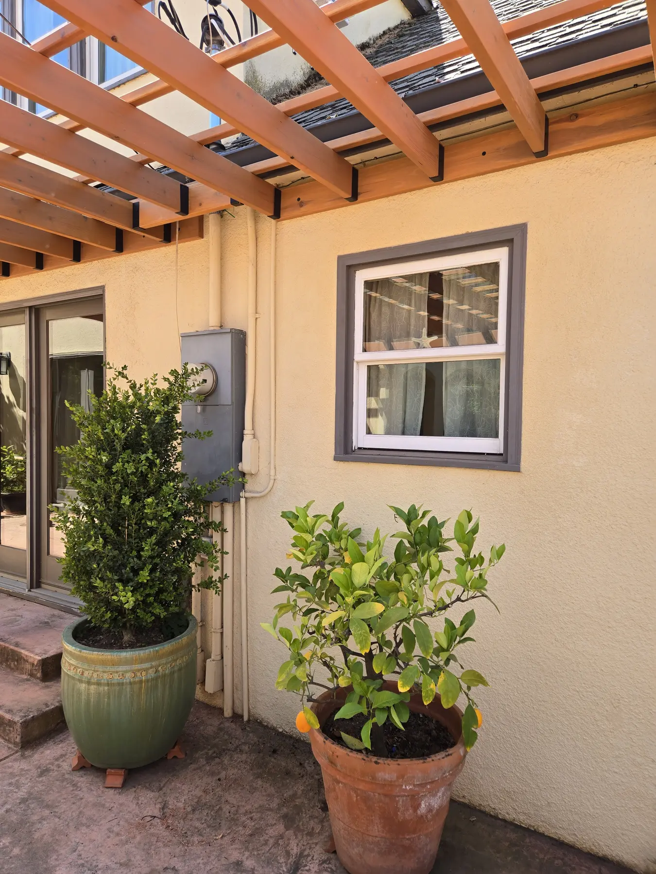 Finished wood dining pergola alongside an East Sacramento home