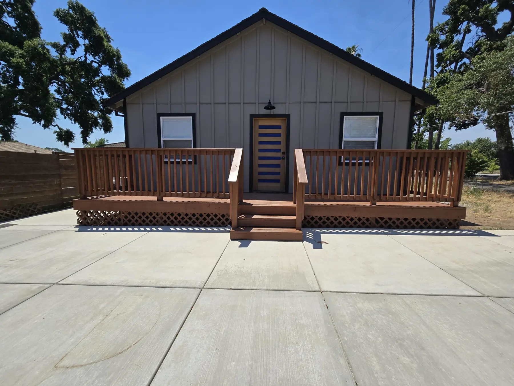 Completed Fair Oaks ADU with full-width wood entry deck