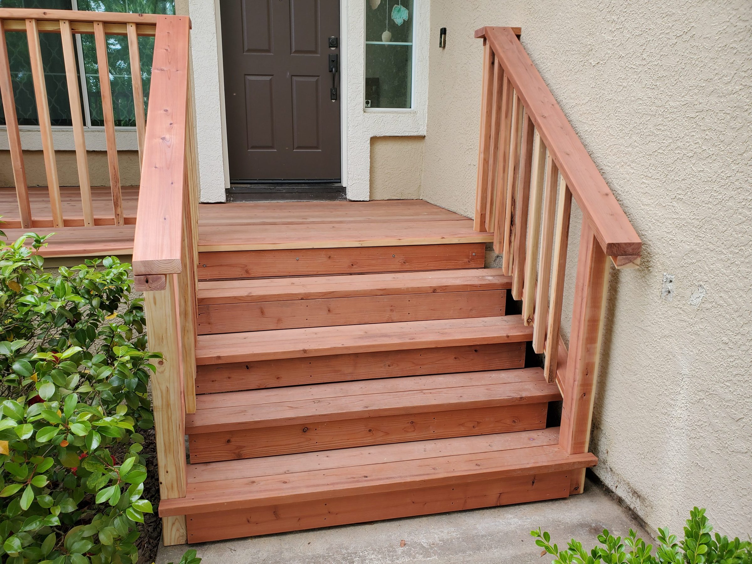 Close view of the wood entry steps and handrails