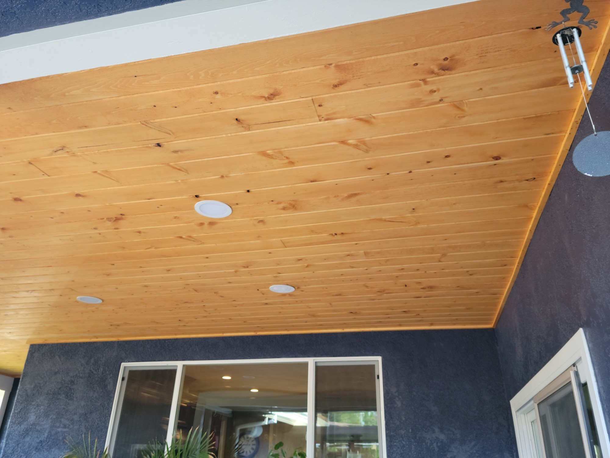 Cedar soffit ceiling meeting the exterior wall and window trim