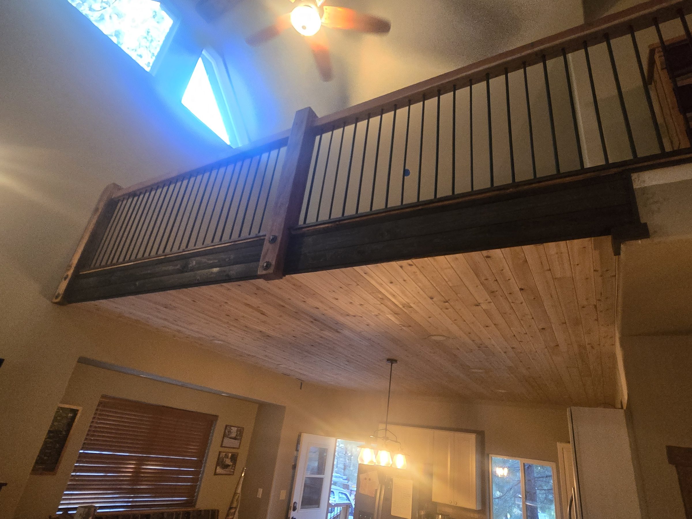 Loft with new hardwood flooring, stair railing and patched drywall