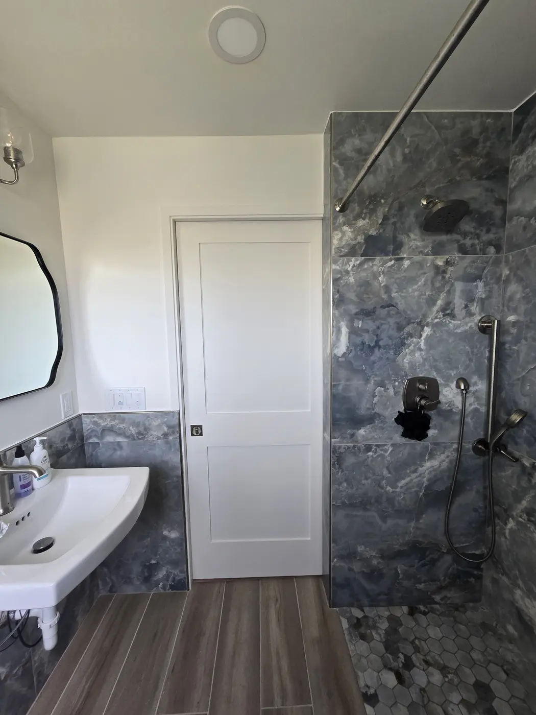 Detailed view of tiled shower niches and coordinated floor finish