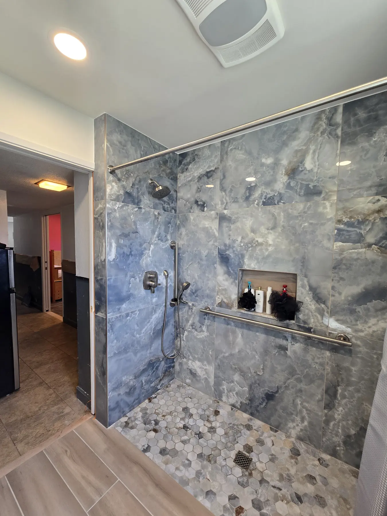 Finished bathroom with full-height blue-gray stone shower wall