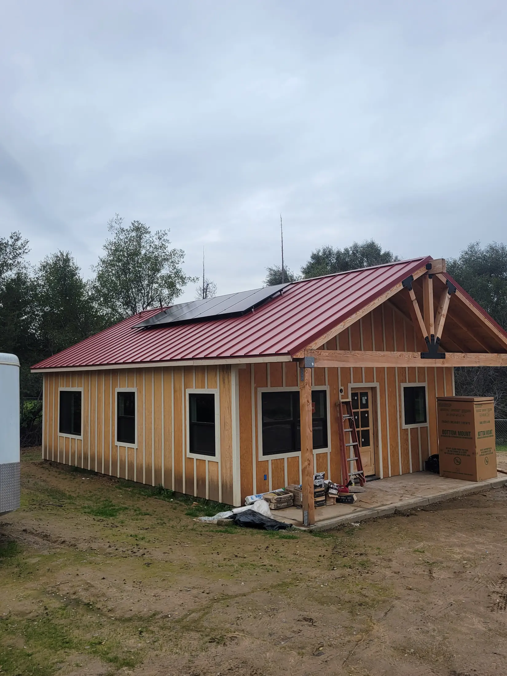 Completed Orangevale ADU with warm siding and a red metal roof