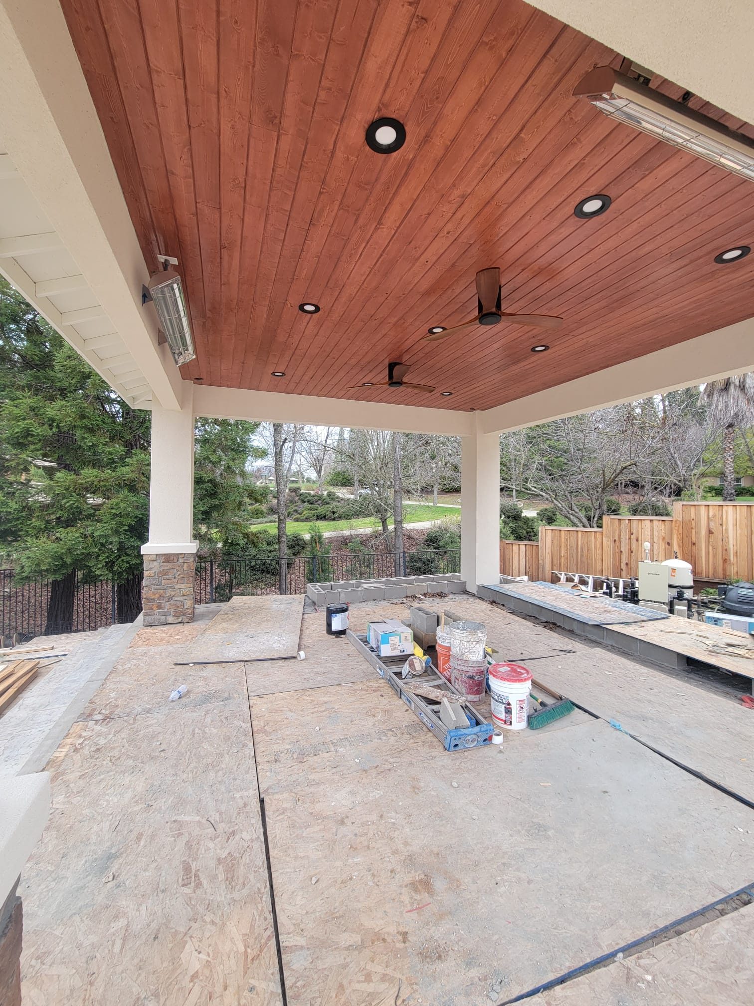 Covered structure with stucco columns before the floor is finished