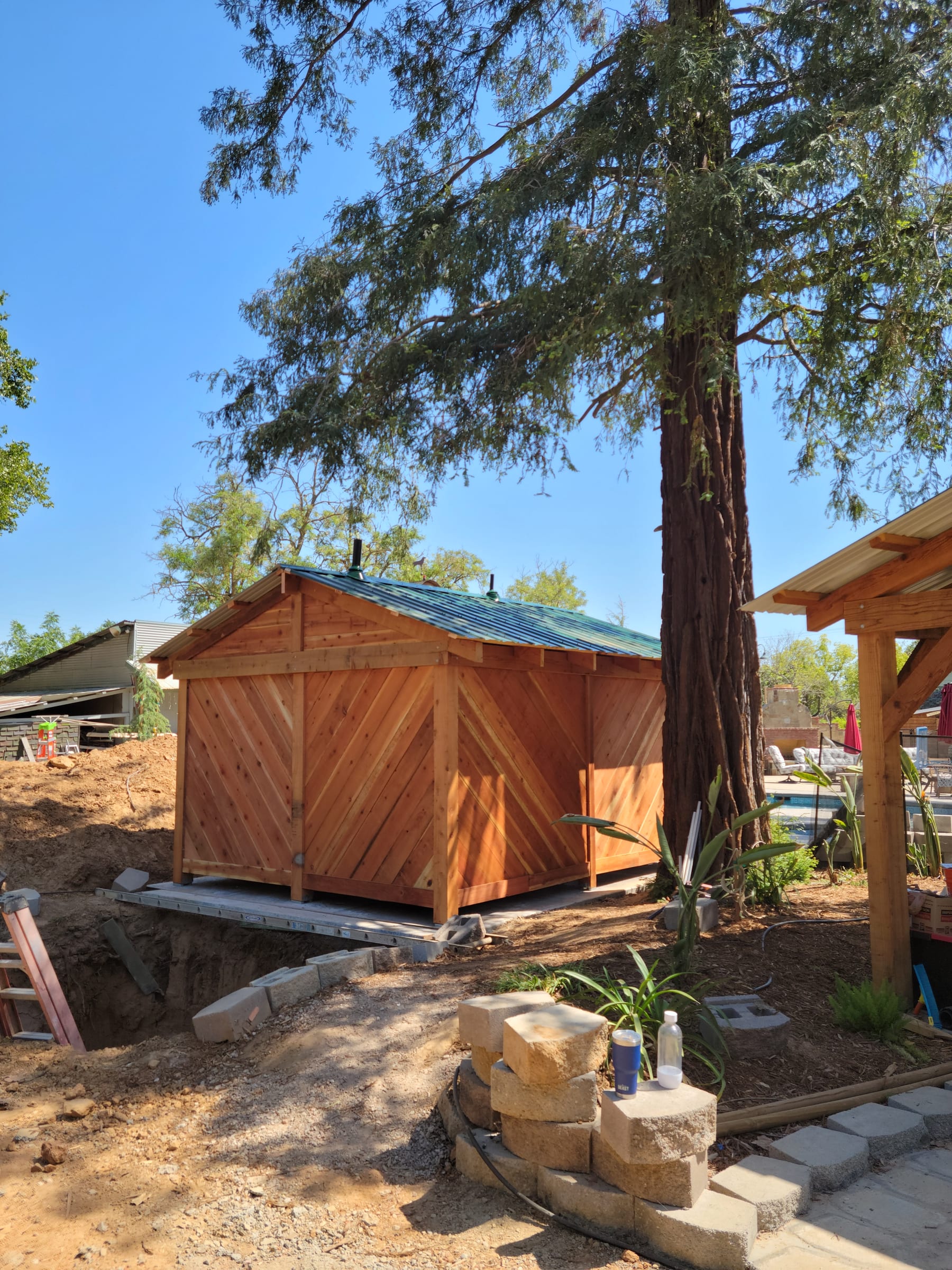 Pool bathroom structure, three-quarter view with driveway access