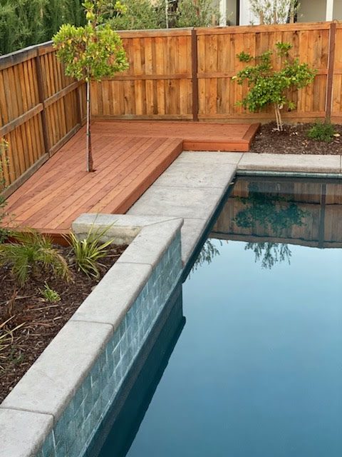 Pool deck next to the water and coping