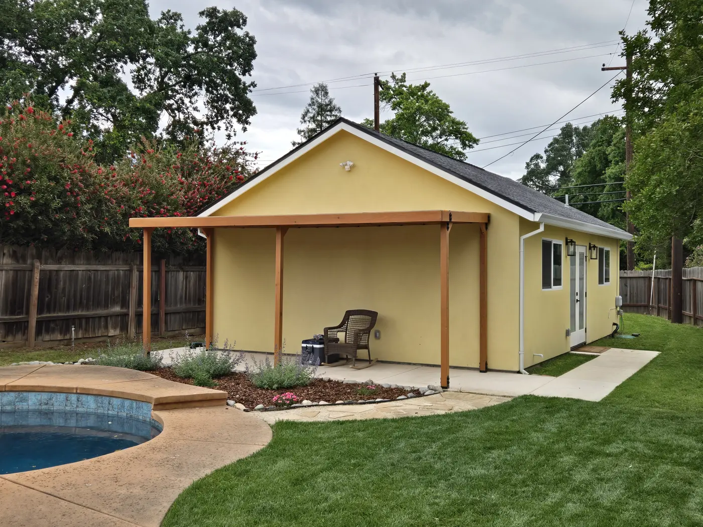 Closer view of finished shade structure posts, roof, and pool edge