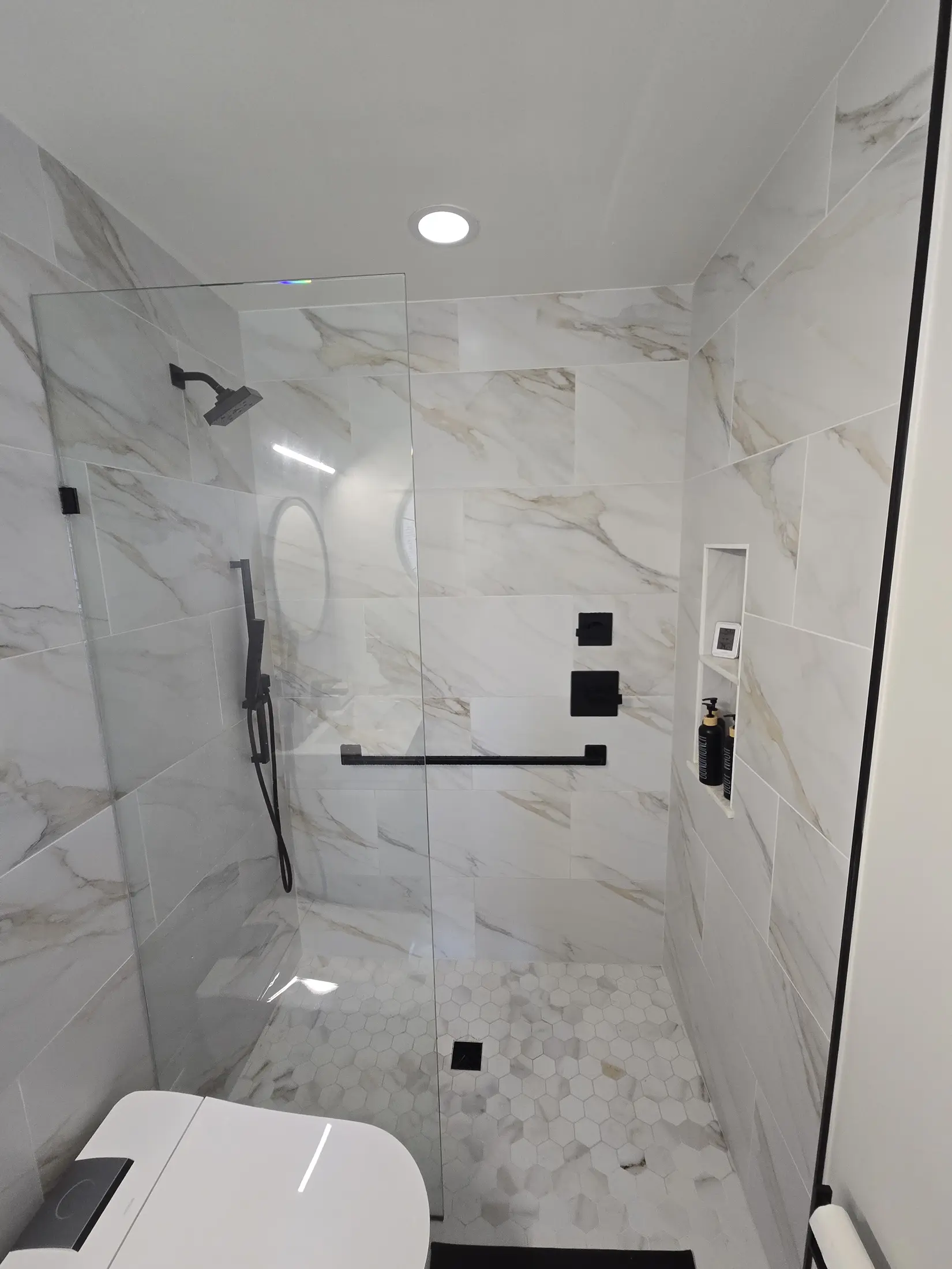 Second view of the compact tiled wet room and recessed shower niche